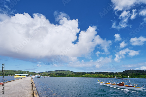 Concrete pier on the sea shore in beautiful sunny day.