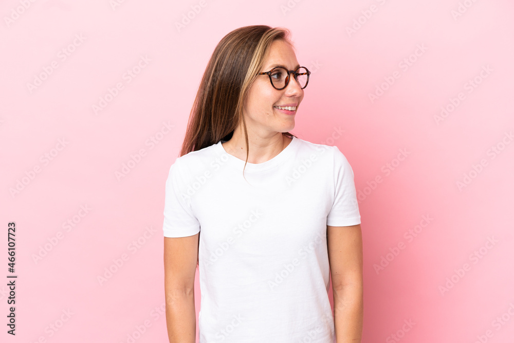 Young English woman isolated on pink background looking side Young English woman isolated on pink background looking side
