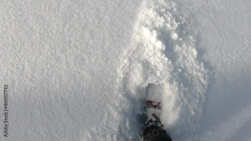 Snowshoeing in the fresh snow. Mountain paths. POV, hiker point of view. Close up to the snowshoes. Step on fresh snow