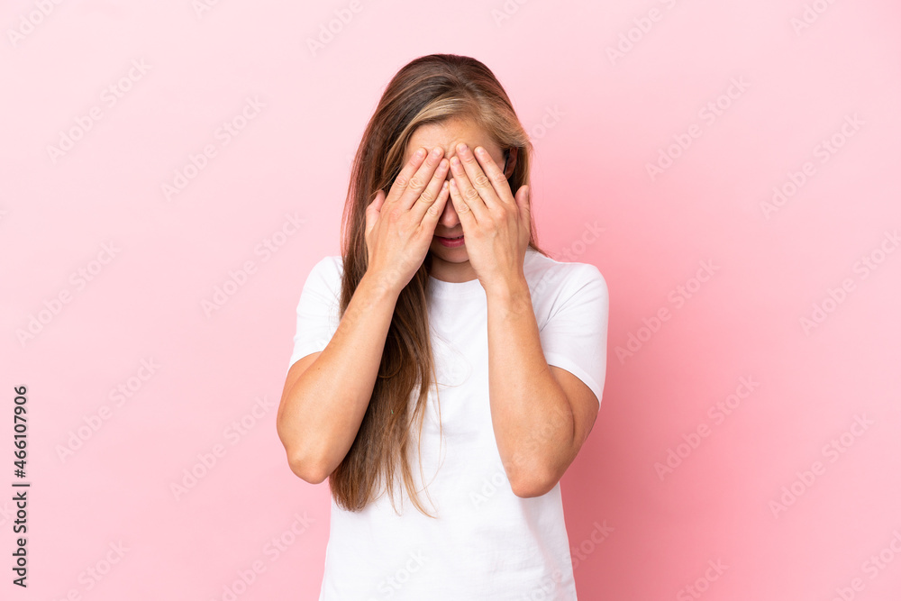 Young English woman isolated on pink background with tired and sick expression