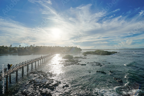 Beautiful landscape. Sunset on the seashore. Wooden bridge on Cloud 9 beach  Siargao Island Philippines.