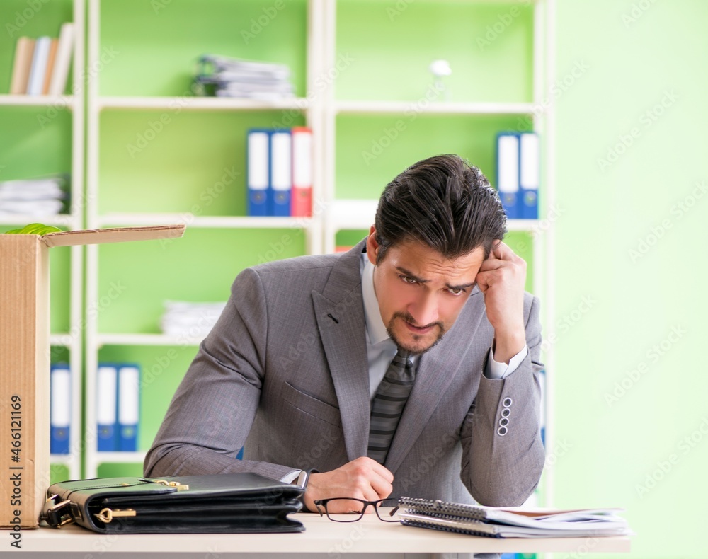 Unhappy tired businessman sitting in the office Unhappy tired businessman sitting in the office