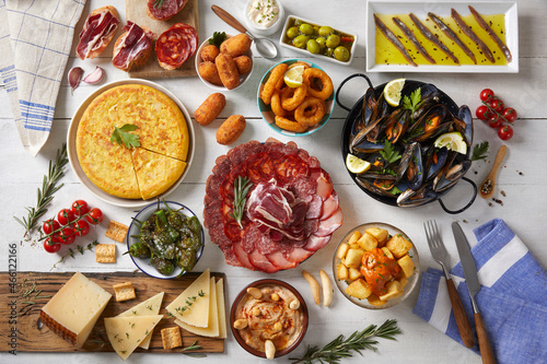 Fototapeta Naklejka Na Ścianę i Meble -  A wooden table with typical Spanish food seen from above