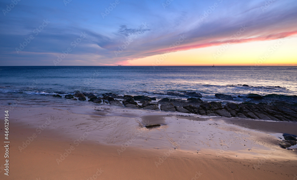 Evening over the beach of Carcavelos Portugal. Ships leaving Lisbon port. Evening over the beach of Carcavelos Portugal. Ships leaving Lisbon port.