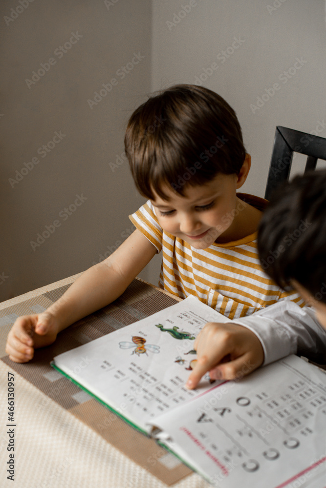 the older brother teaches the younger to read the older brother teaches the younger to read