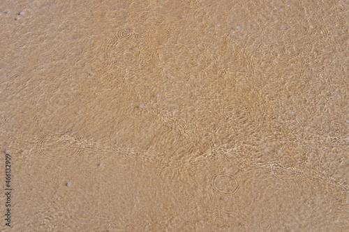 Small wave with sand in a beach