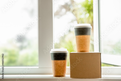 coffee in cardboard brown cups ordered and delivered for takeaway, food delivery, takeout, copy space for text. photo