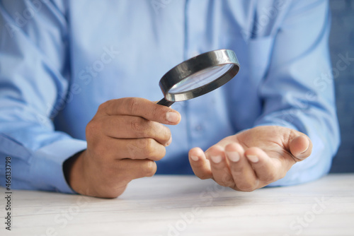 Wall Mural young men discovering his luck with magnifying glass