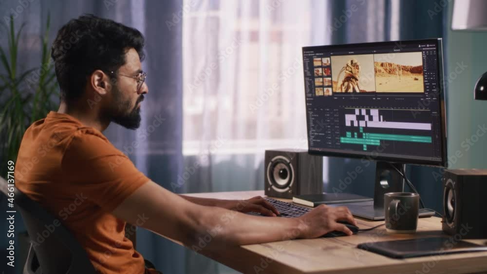 Indian man editing video in home office