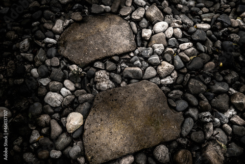 Monochromatic image of rocks and gravels in the Japanese-style garden. Wabi-sabi style garden footpath over the beach stones.