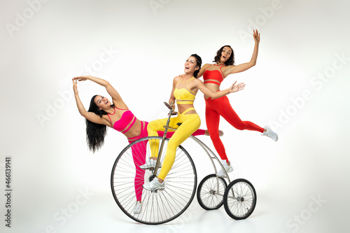 Excited fitness team having fun with old fashioned trike © Admiral