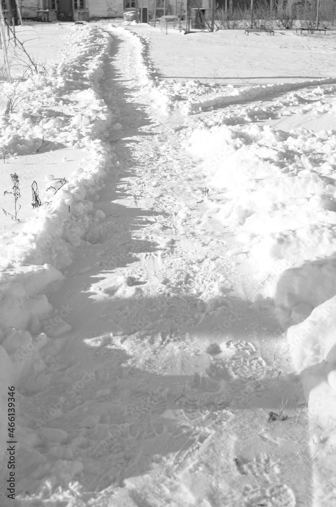 Snowy path in deep snow. Pure white snow on a clear sunny day