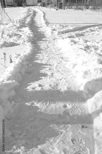 Snowy path in deep snow. Pure white snow on a clear sunny day