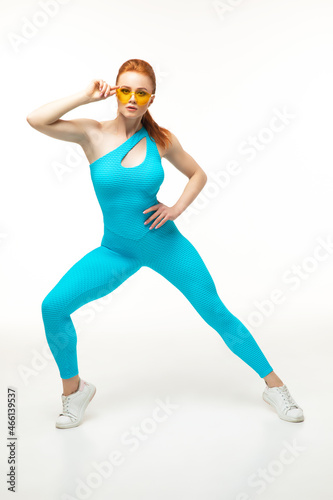 Confident sportswoman lunging and adjusting sunglasses © Admiral