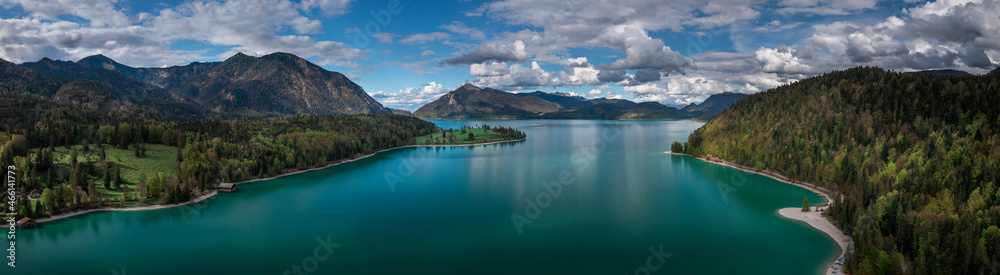 Mountain panorama of turquoise coloured Lake Walchensee with blue sky from above, Bavaria.