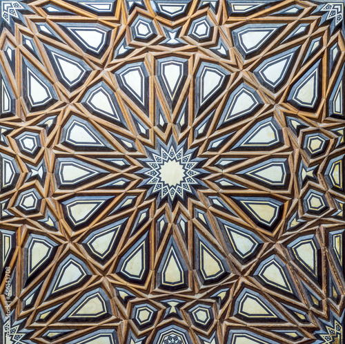 Closeup of wooden arabesque decorations tongue and groove assembled, inlaid with ivory and ebony, on door of minbar of historic public Mosque of Al Rifai, Old Cairo, Egypt