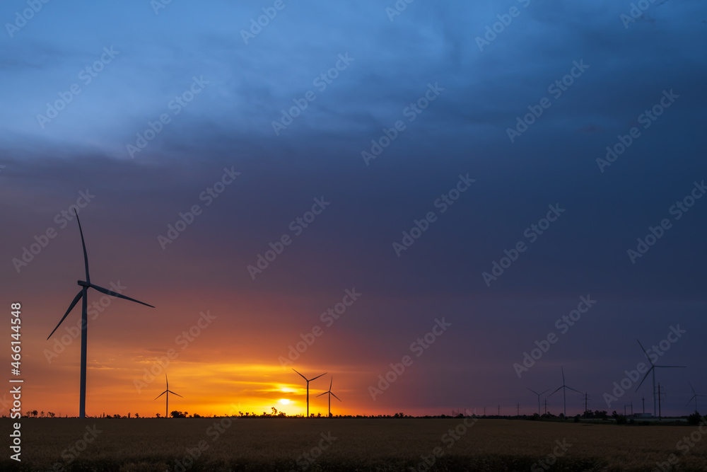 Fototapeta premium Wind turbines at dawn. Picturesque view of the wind power generator. Production of environmentally friendly energy.