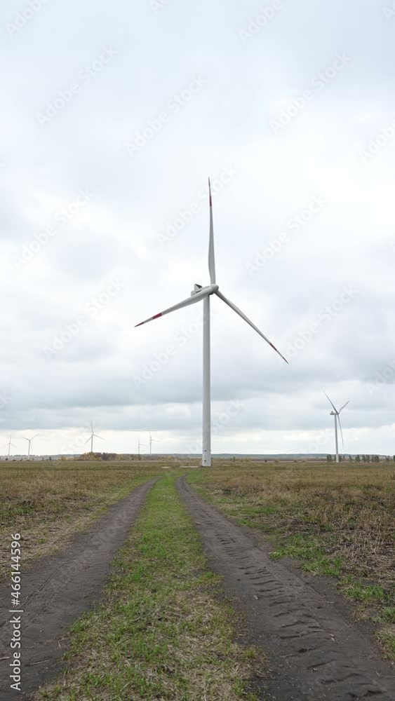 Large wind turbines with blades in the wind park on the background cloudy sky. Large wind turbines with blades in the wind park on the background cloudy sky.