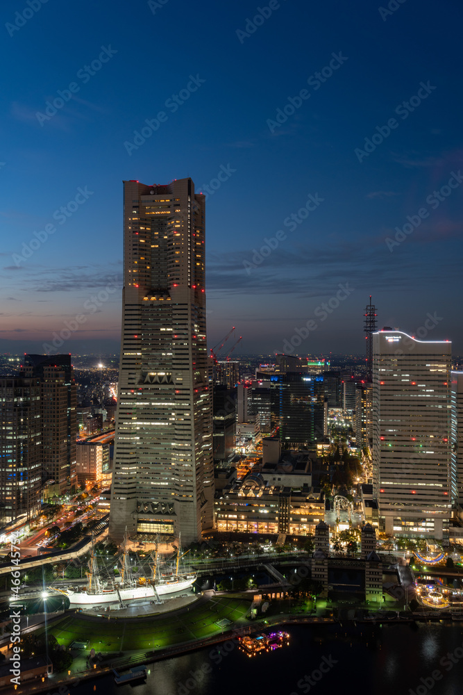 Obraz premium Vertical image of Yokohama Minato Mirai 21 seaside urban area in central Yokohama with Landmark tower at Magic hour
