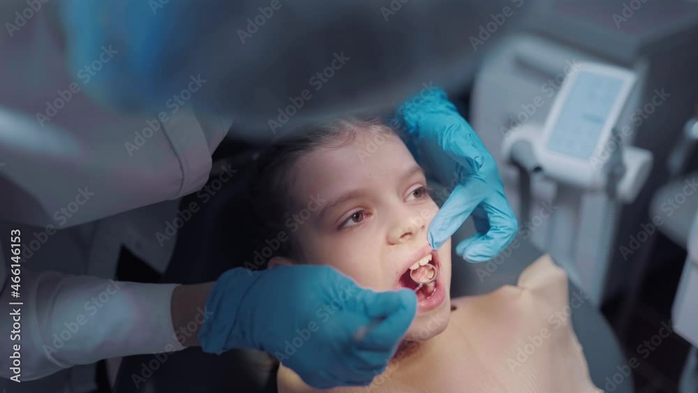 Close up face of little girl patient with open mouth during dental check up prevention toothache. Close up face of little girl patient with open mouth during dental check up prevention toothache.