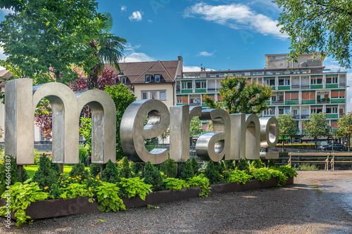 Canvas Print In the public gardens in the center, the name of the city made of gray metal with brightly colored flowers at the base
