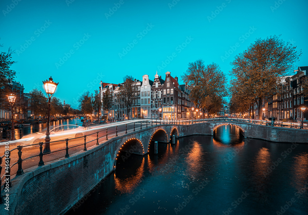 Blue hour image of the Amsterdam Leidsegracht canal with lighttrail and arched bridges
