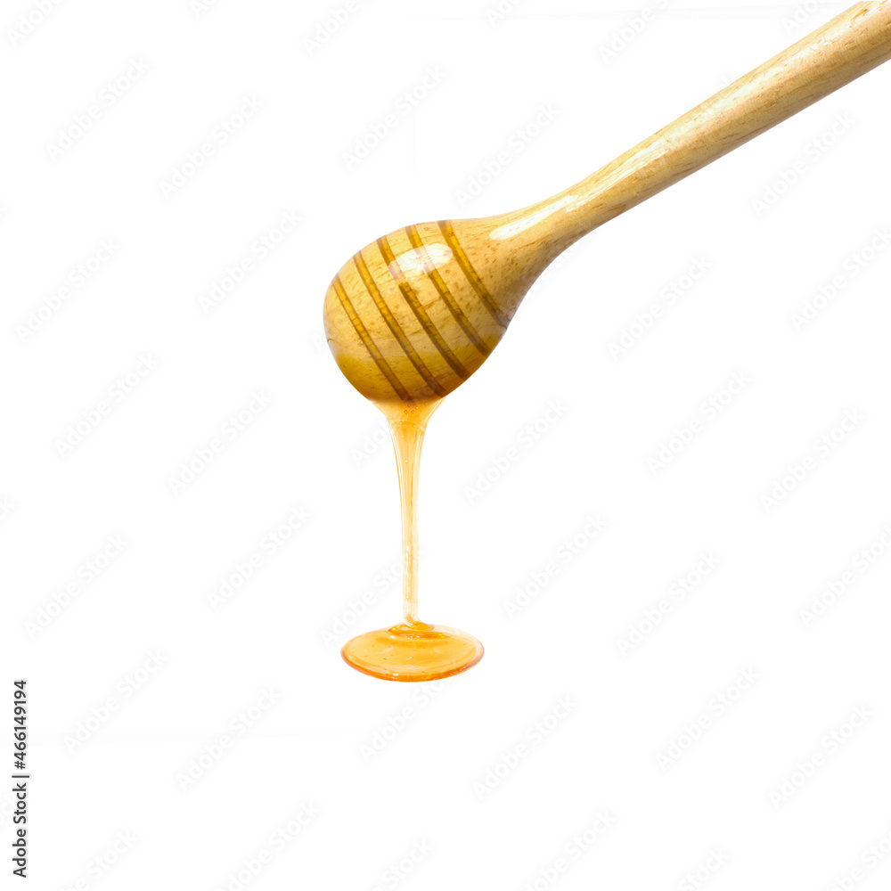 honey dripping from a wooden dipper honey dripping from a wooden dipper