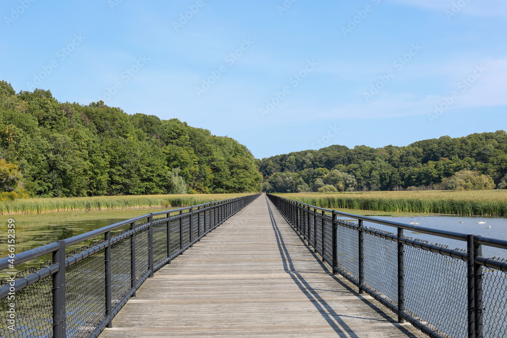 Boardwalk along the Genesee river at Turning Point park in Rochester, New York. View of the 3,572 ft.-long bridge at the turning point on the river.