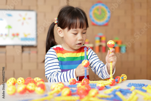 young irl playing creative toy blocks at home