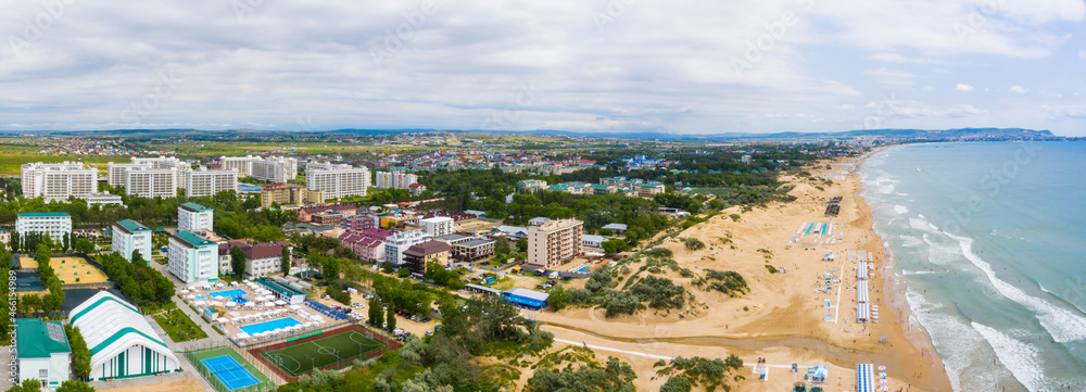 A picturesque panorama of the sea coast with a sandy beach in a resort near the city of Anapa and the village of Vityazevo.