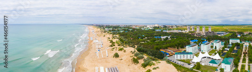 A picturesque panorama of the sea coast with a sandy beach in a resort near the city of Anapa and the village of Vityazevo. © miklyxa