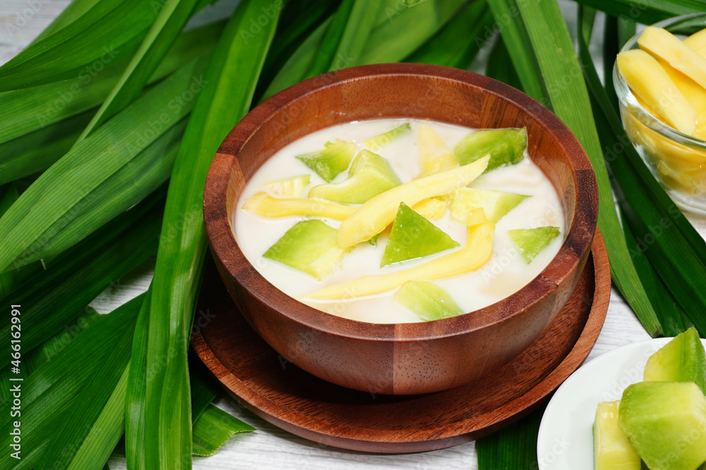 Thai dessert, melon and yellow jackfruit Topped with sugar syrup, fresh coconut milk and pandan leaves add aroma Thai dessert, melon and yellow jackfruit Topped with sugar syrup, fresh coconut milk and pandan leaves add aroma