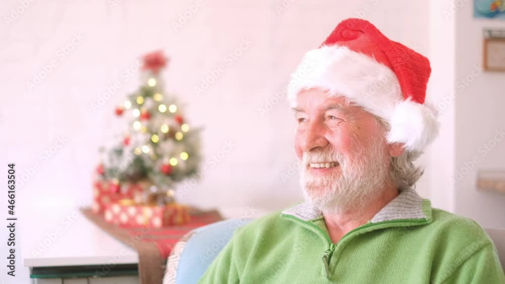 Portrait of smiling retired senior man in santa hat and warm clothing celebrating christmas at home. Old male santa smiling while looking at camera. Elderly man enjoying christmas holiday
Portrait of smiling retired senior man in santa hat and warm clothing celebrating christmas at home. Old male santa smiling while looking at camera. Elderly man enjoying christmas holiday