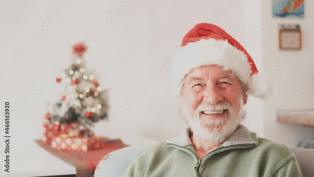 Portrait of smiling retired senior man in santa hat and warm clothing celebrating christmas at home. Old male santa smiling while looking at camera. Elderly man enjoying christmas holiday
Portrait of smiling retired senior man in santa hat and warm clothing celebrating christmas at home. Old male santa smiling while looking at camera. Elderly man enjoying christmas holiday
