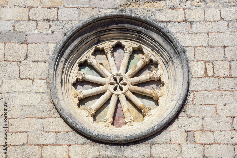 Rose window of facade of ancient church. Montenegro, Old Town of Kotor, Catholic Church of St Clare, detail