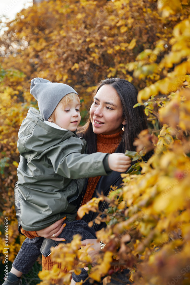 beautiful woman with a baby in her arms. in the park beautiful woman with a baby in her arms. in the park