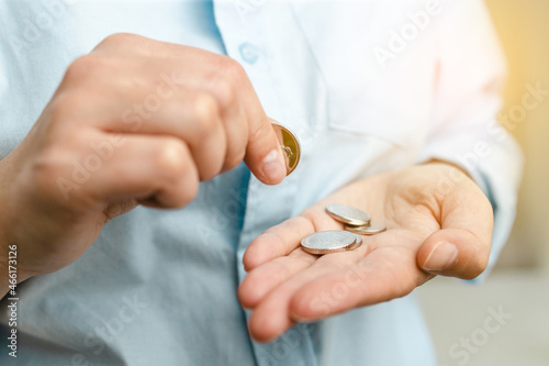 Business finance saving and investment concept. Woman holding silvery coins in her hand