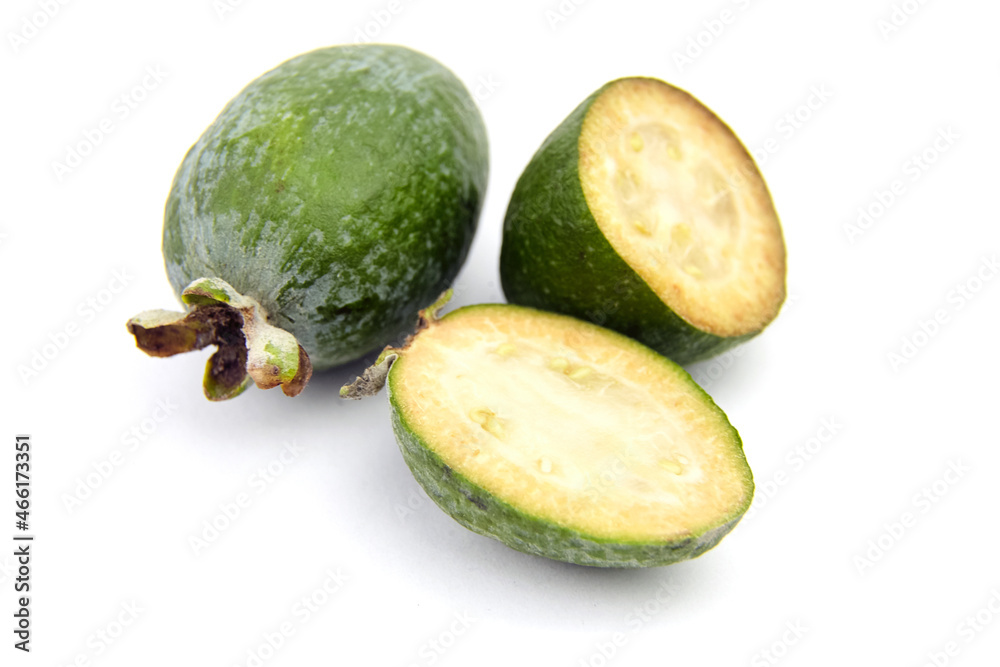 Feijoa fruit or whole and half pineapple guava isolated on white Feijoa fruit or whole and half pineapple guava isolated on white