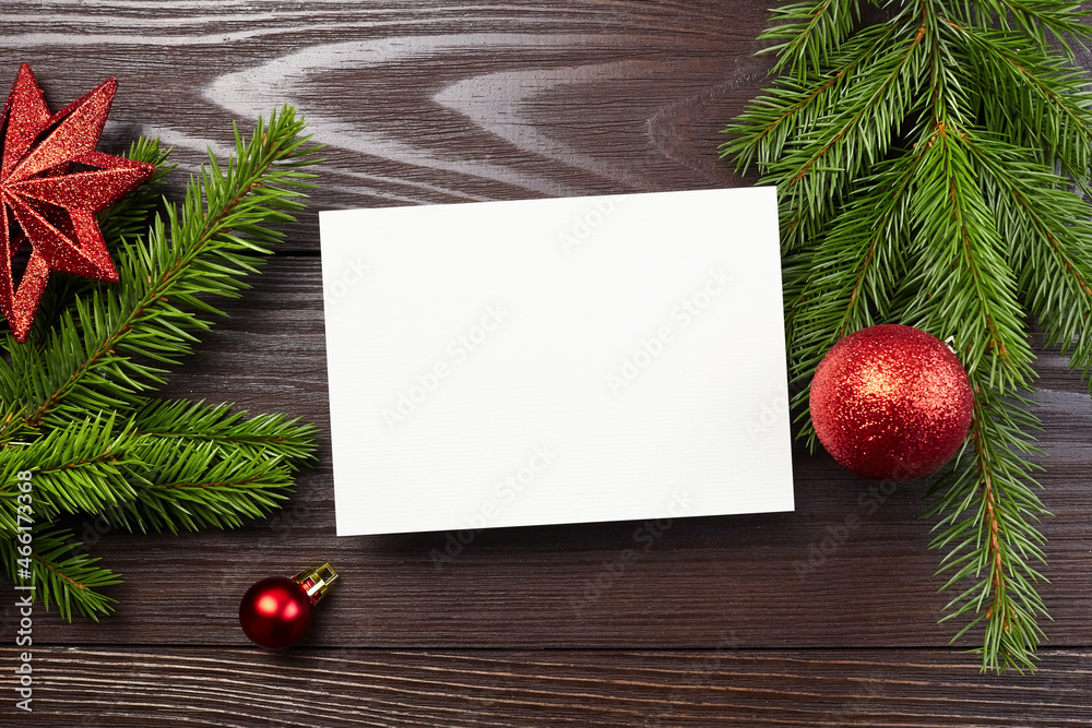 Christmas or New Year greeting card mockup with red festive decorations and fir tree branches Christmas or New Year greeting card mockup with red festive decorations and fir tree branches