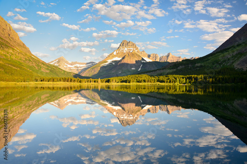 Mount Wilbur and cloud formation reflected in Swiftcurrent Lake photo