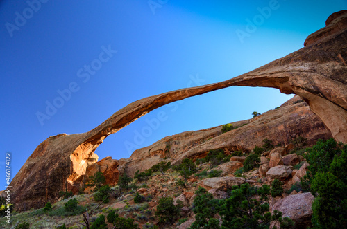 Looking up at Landscape Arch with blue sky background, Arches National Park, Utah