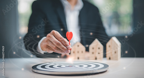 Targeting the business and home concept, Businessman throwing red arrow dart to virtual target dart board,Executive marketing, investment goal and target for business investment concept.