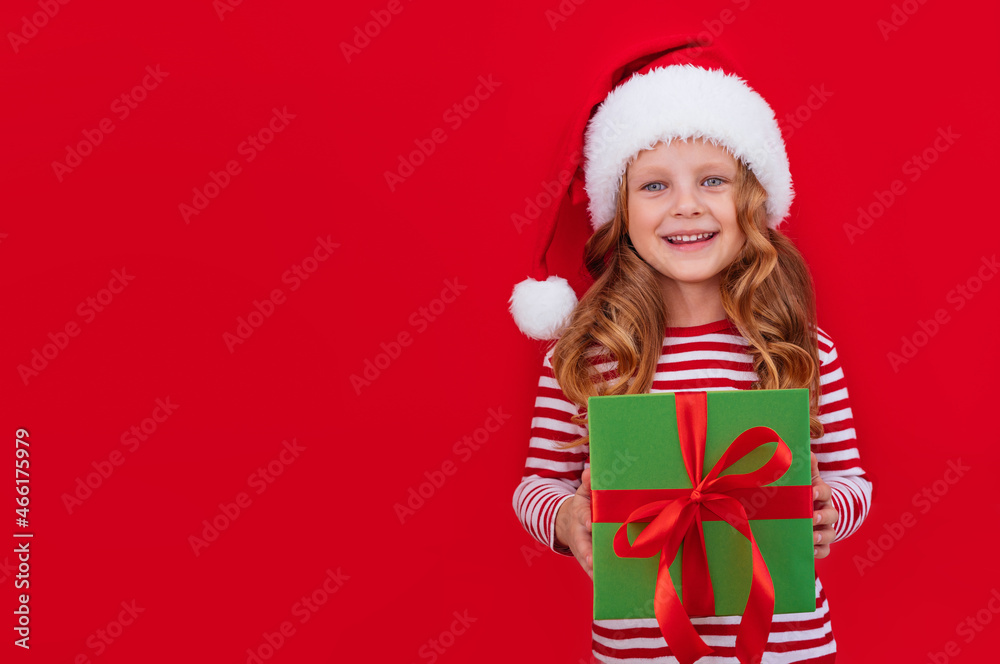 Christmas banner child in a santa hat holding a gift on a red background with place for text
Christmas banner child in a santa hat holding a gift on a red background with place for text