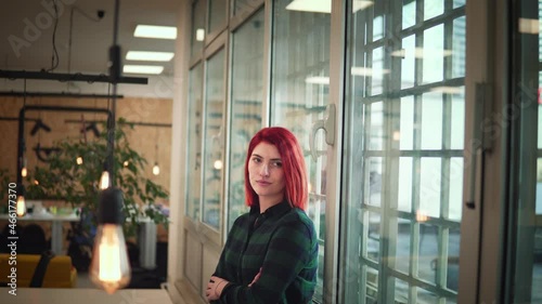 Portrait of young female developer as a successful independent businesslady posing in a modern office. Business, start up, development and feminisam concept photo