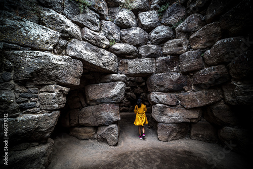 Tableau sur toile Woman visiting an ancient nuraghe in Sardinia