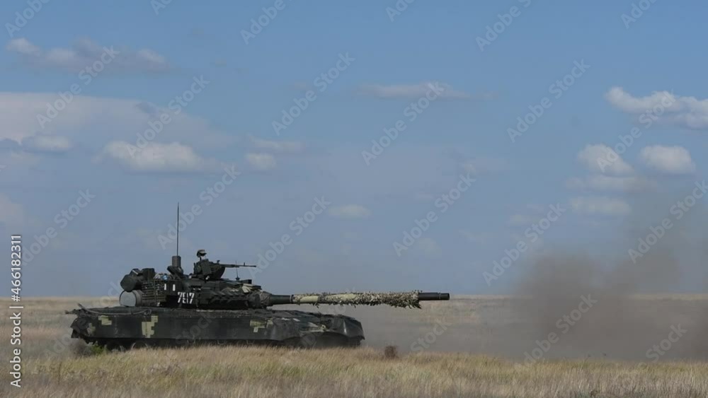 Heavy armored Ukrainian T-80 tank hooting in sand side view. Powerful army technology created for security and defense. Armed military vehicle training to defend people. 4k UHD footage. Heavy armored Ukrainian T-80 tank hooting in sand side view. Powerful army technology created for security and defense. Armed military vehicle training to defend people. 4k UHD footage.