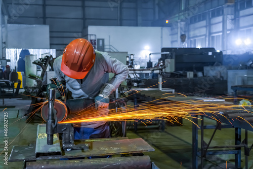 Rotation of the angle grinder disc during operation. Bright sparks from metal cutting. Preparation of metal structures before welding. © Danil Evskiy