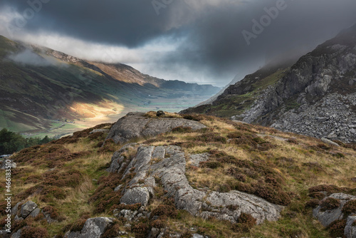 Epic Autumn landscape image of view along Nant Fracon valley in Snowdonia National Park with dramatic evening sky and copy space