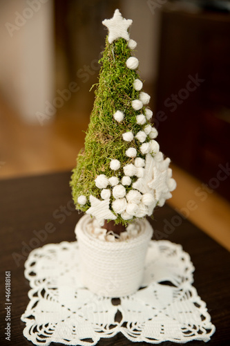 Small Christmas tree. Made of moss. Decorations from orange peel. Christmas spirit at home.