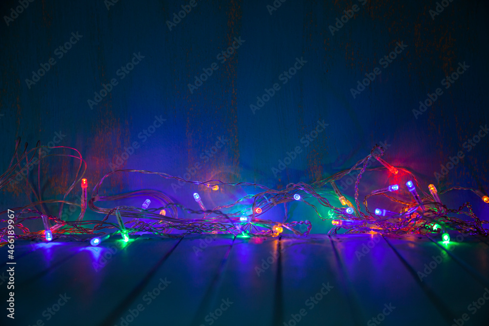 Obraz premium Multicolored festive garland glows in the dark.